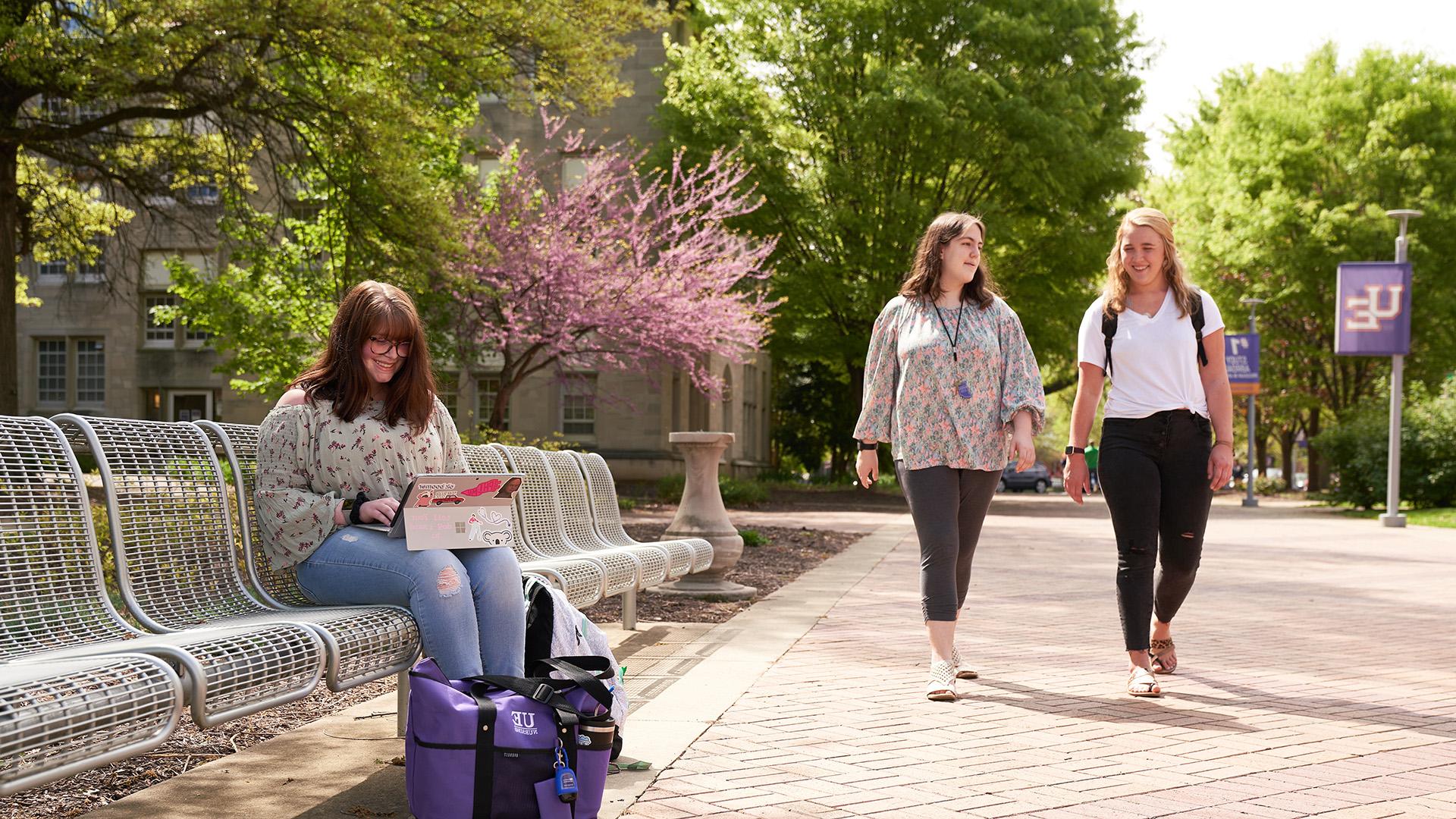Women on campus walking and sitting